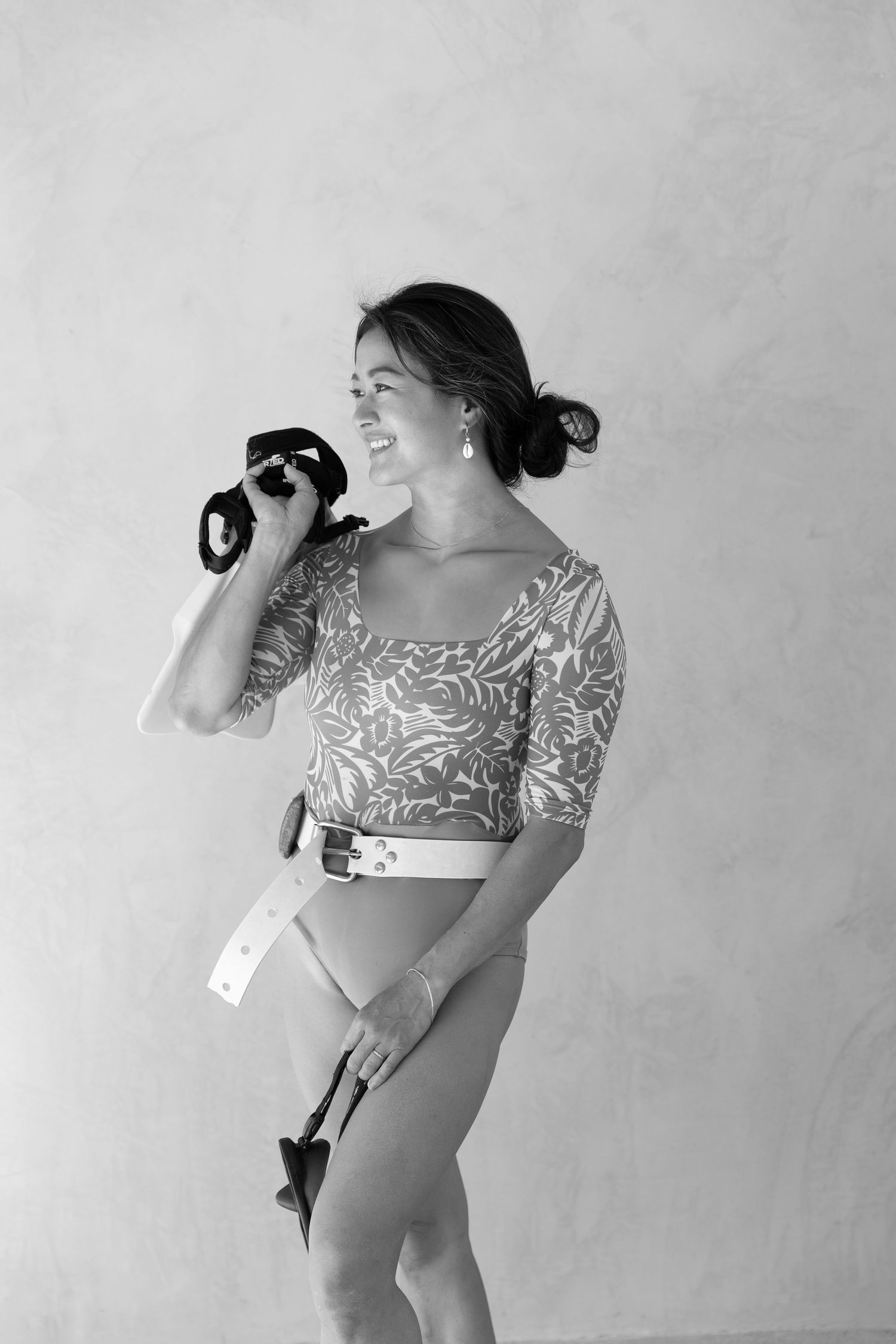 Black and white artistic portrait series showing dynamic poses against plain backdrop.