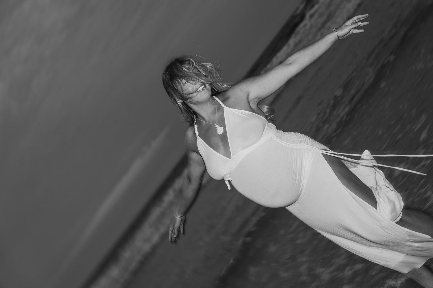 Artistic black and white underwater maternity photography session.