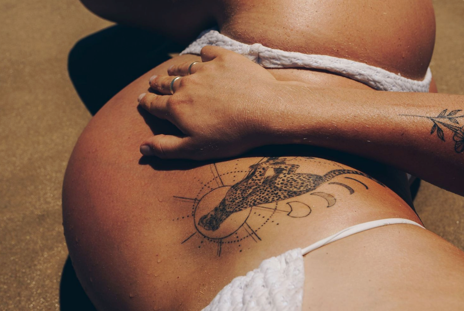 Artistic close-up of intricate tattoo designs on skin.