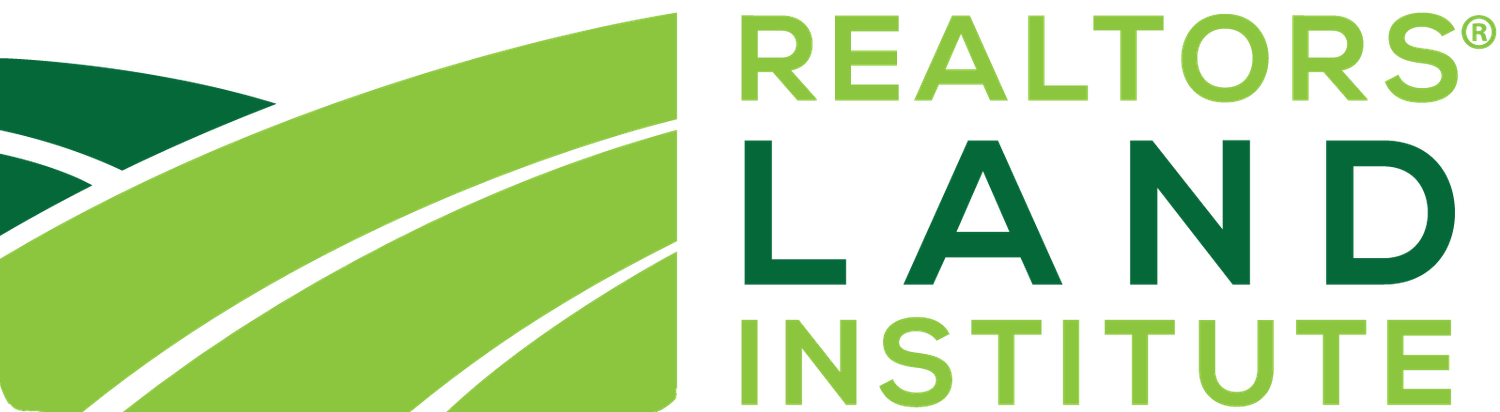 Green and white logo for REALTORS Land Institute featuring a curved design element.