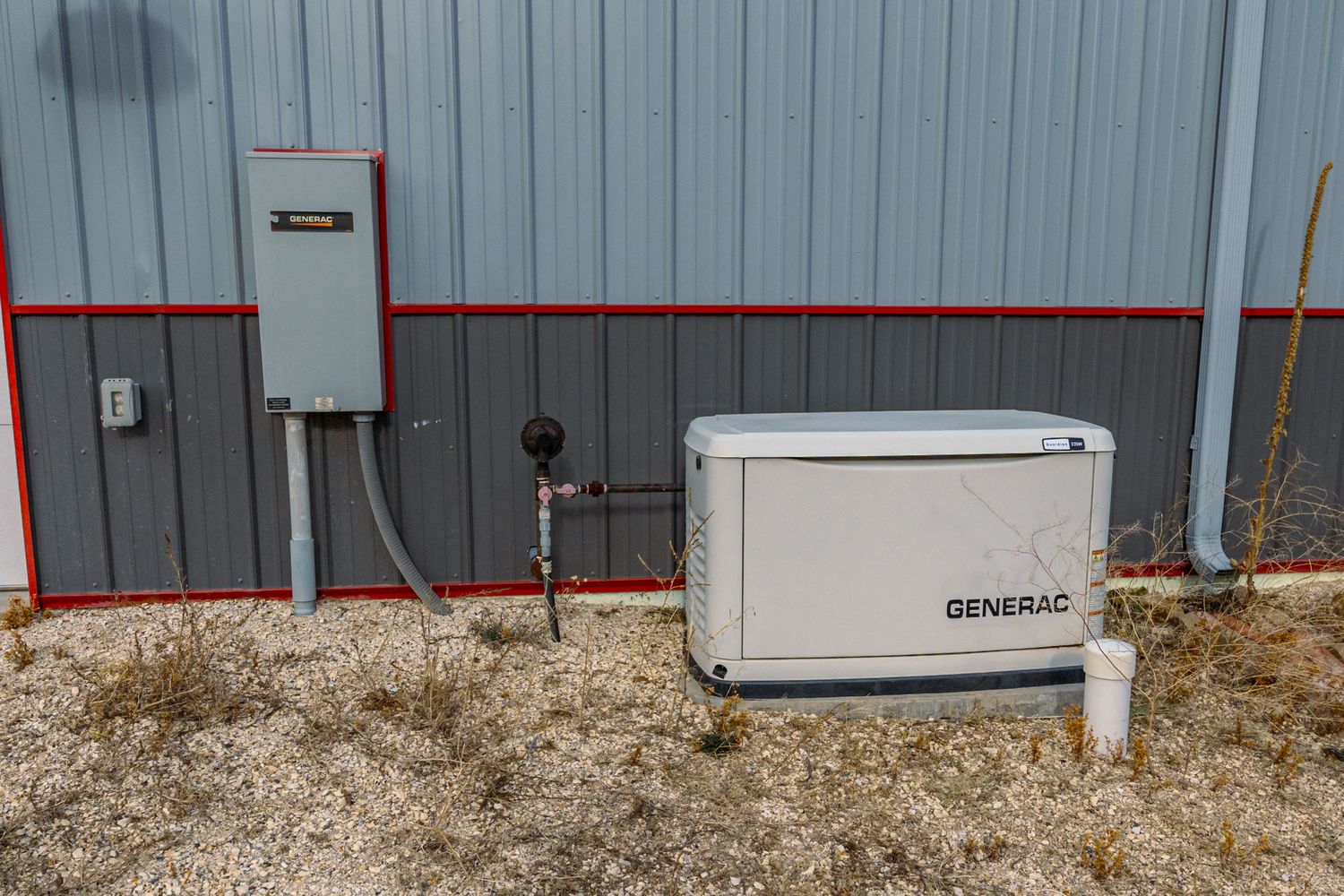 Exterior wall mounted Generac backup generator system with electrical connections.