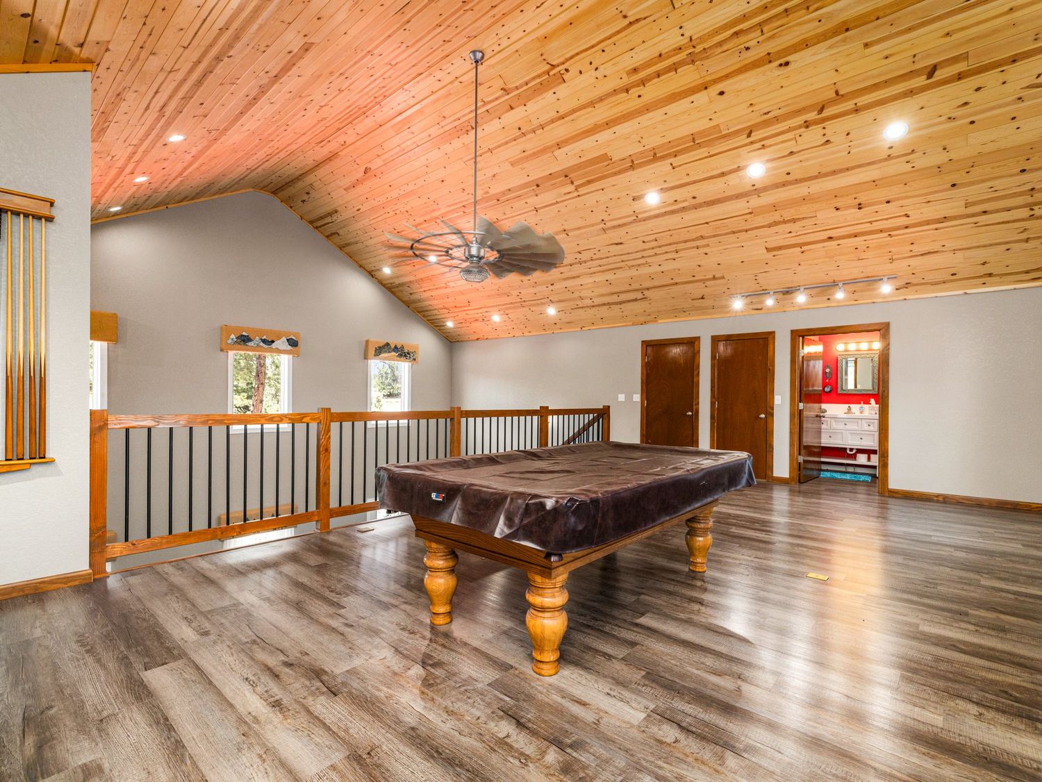 Open loft area featuring a pool table, vaulted wood ceiling, hardwood floors, and railing.