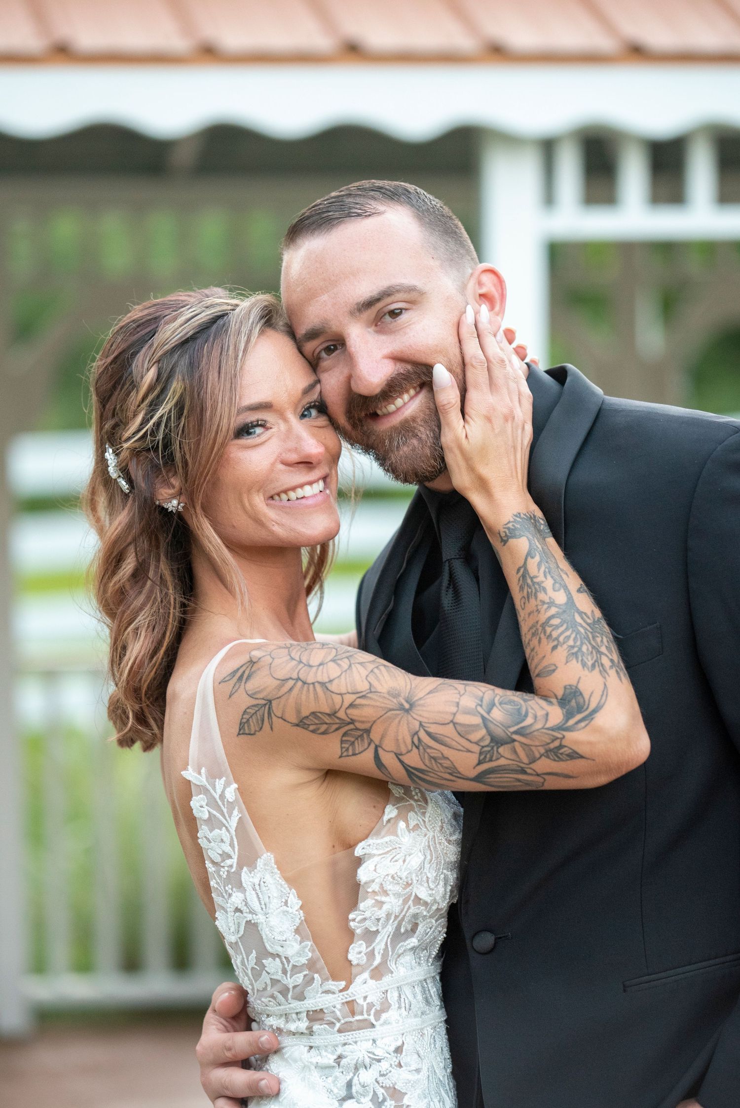 Wedding couple sharing intimate moment outdoors.