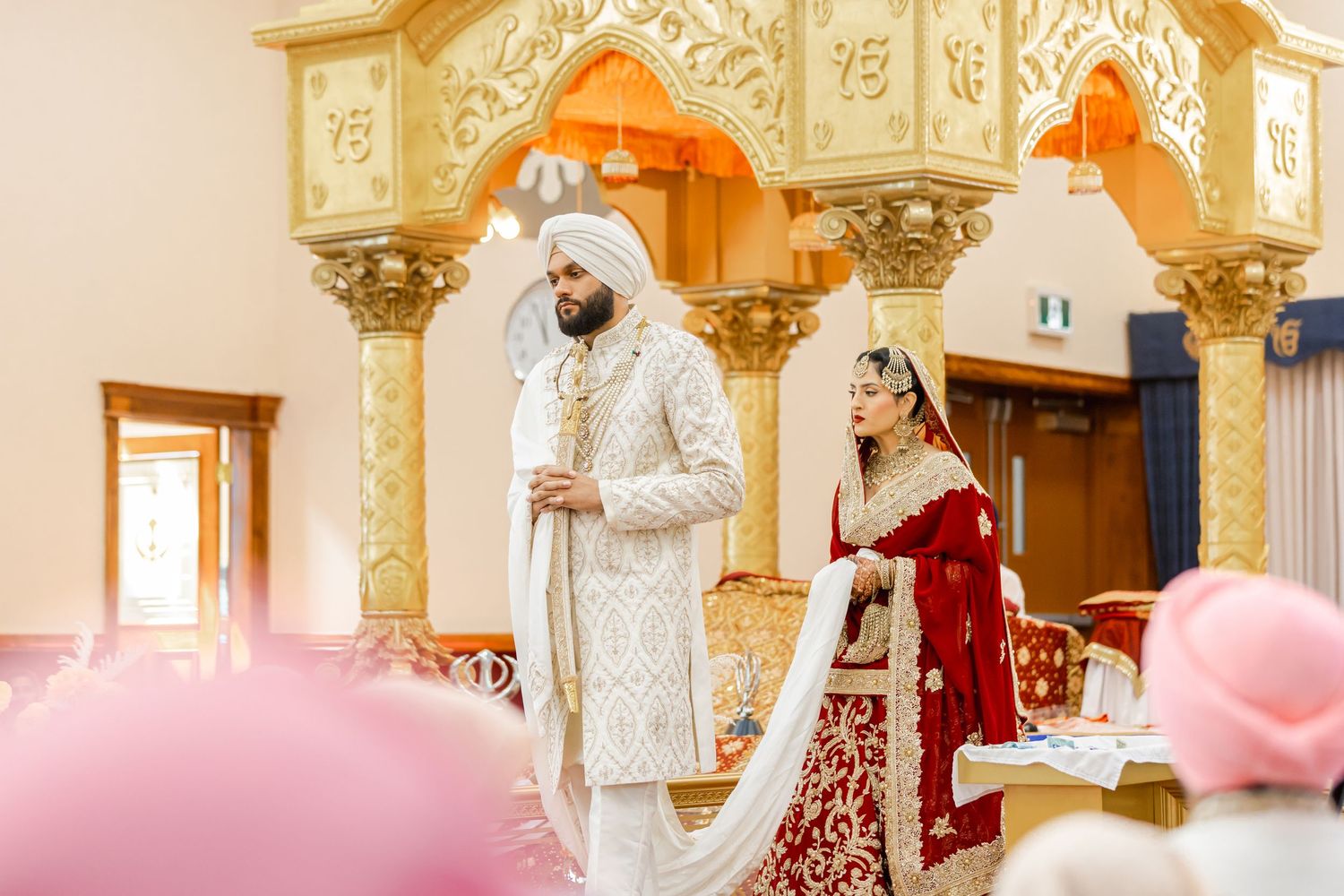 Elegant wedding venue decorated with golden architectural details and columns.