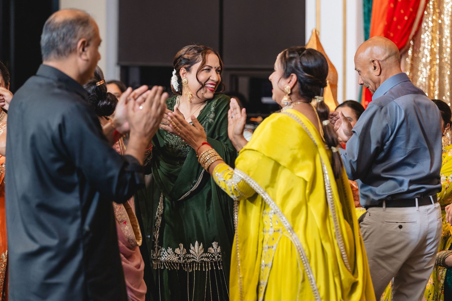 Guests in colorful traditional attire gather at an elegantly decorated wedding celebration.