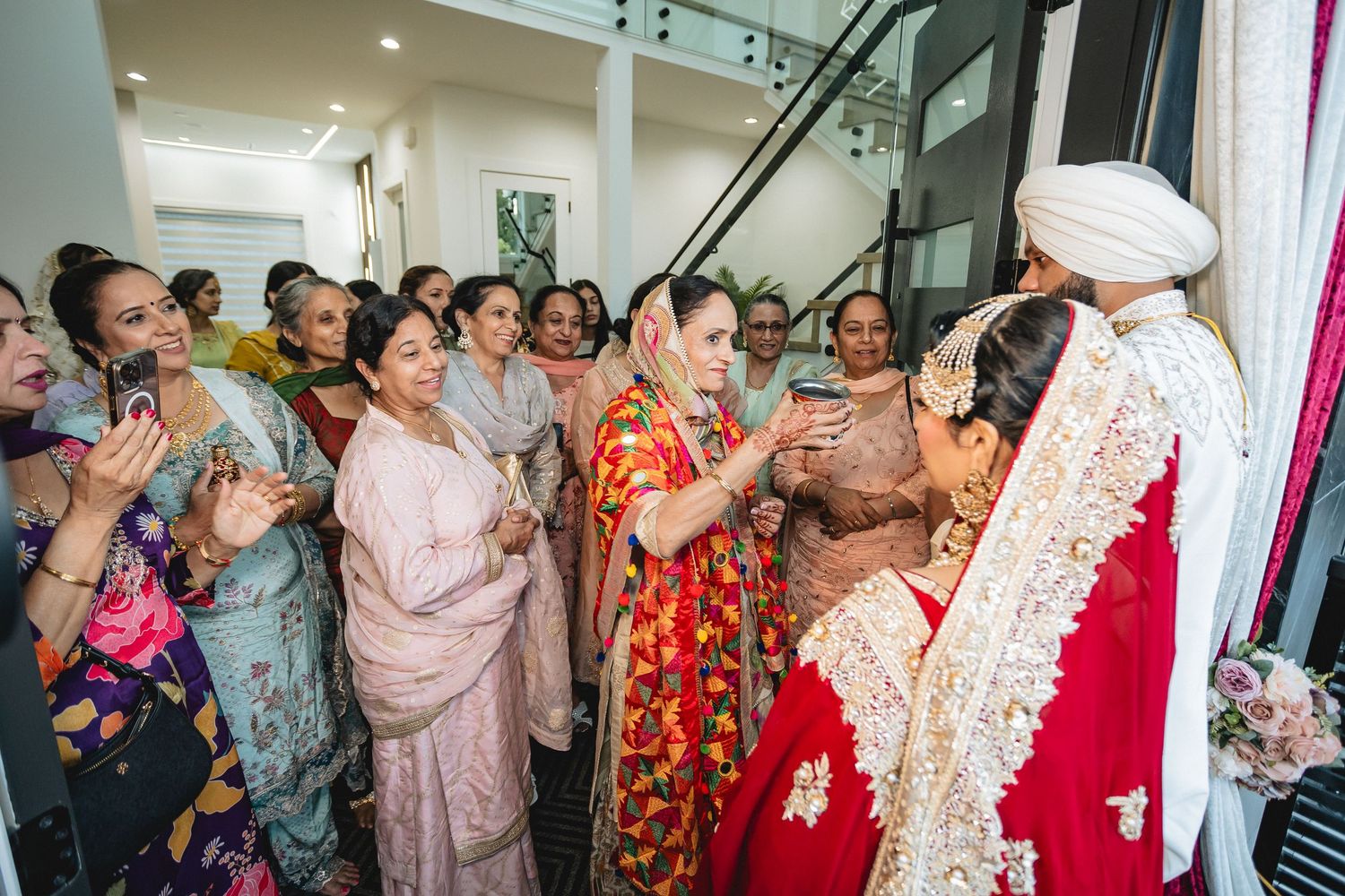 Wedding celebration with guests dancing and celebrating in an indoor venue.