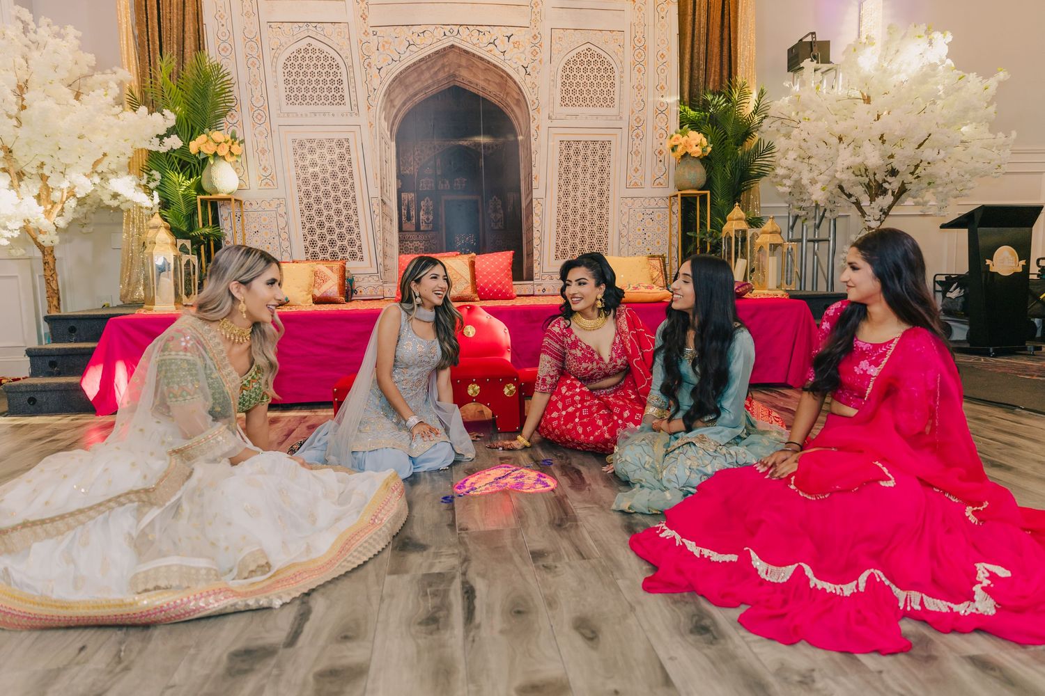 Elegant wedding venue decorated with pink accents and ornate architectural details.