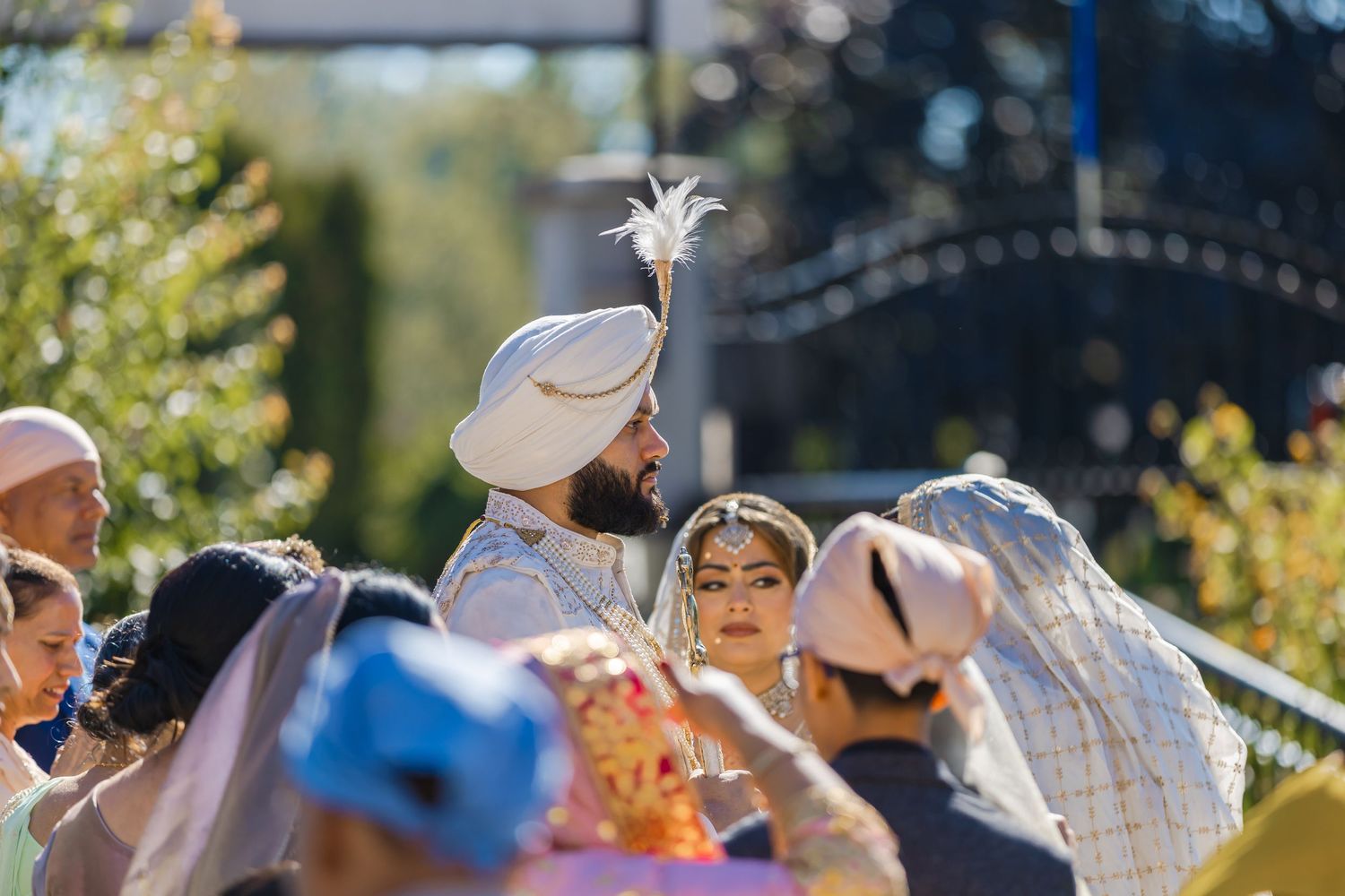 Outdoor wedding celebration with guests gathered in traditional attire.