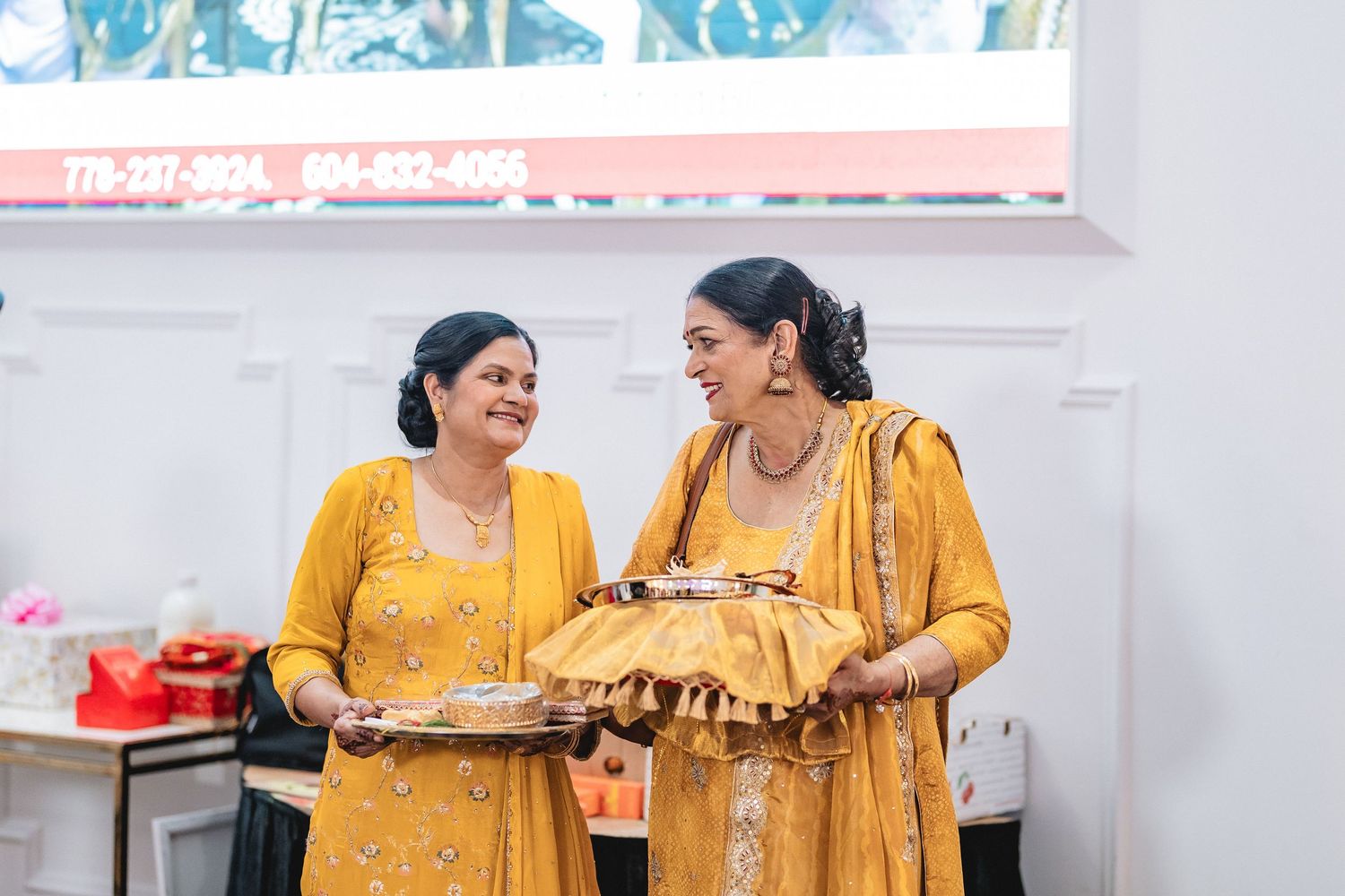 People in yellow outfits share a joyful moment during what appears to be a cultural celebration.