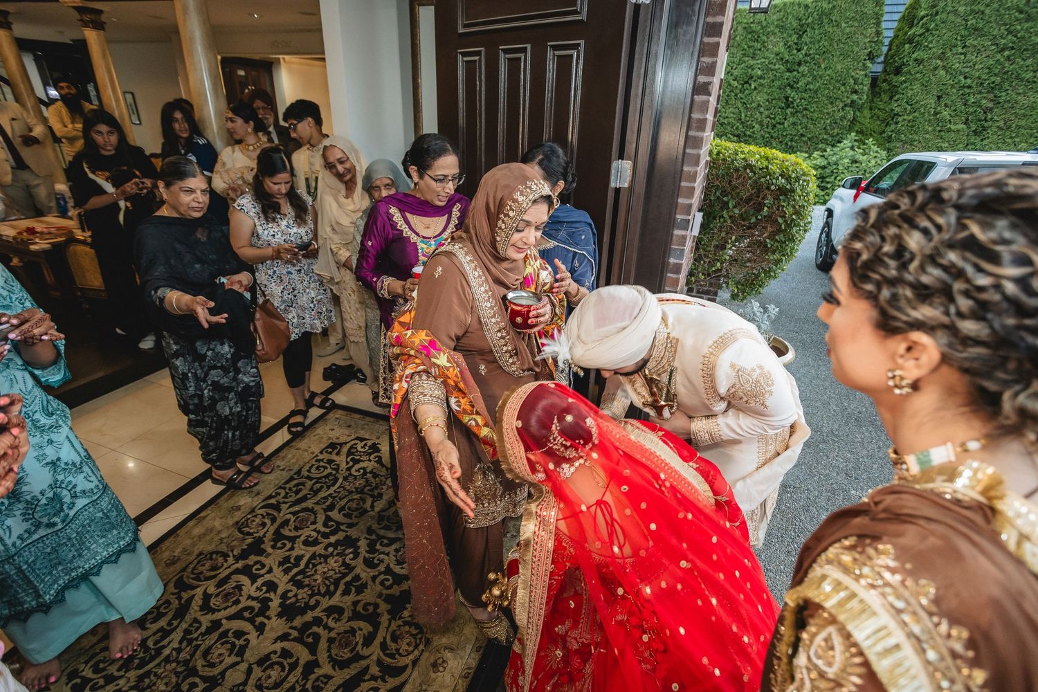 Wedding celebration candid moments with guests in traditional Indian formal wear.