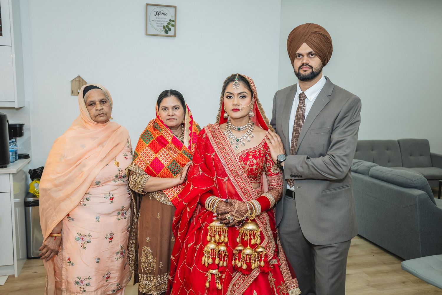 Wedding celebration with guests in traditional Indian formal wear gathered in an indoor setting.