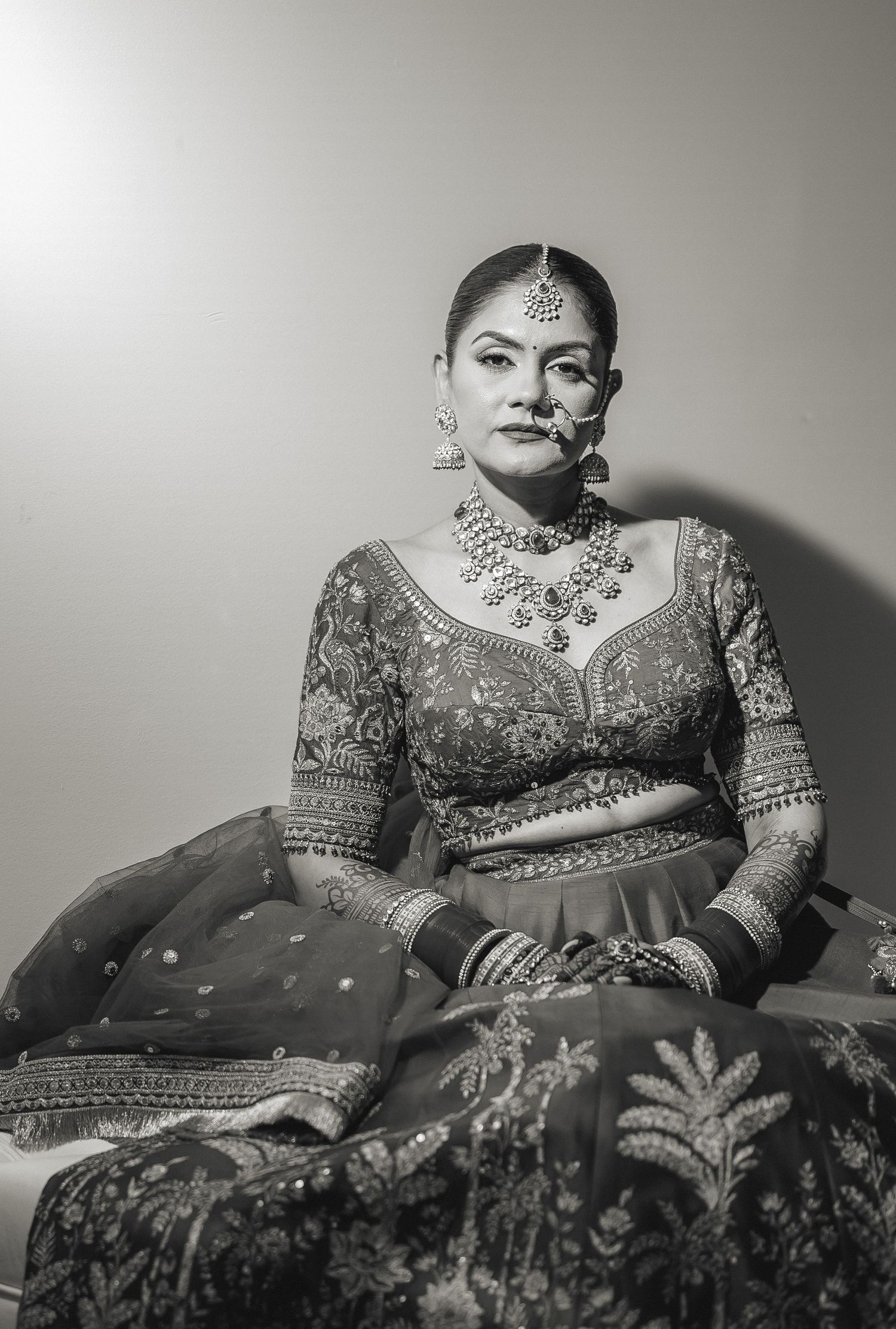 Black and white portrait of bride in traditional South Asian wedding attire and jewelry.