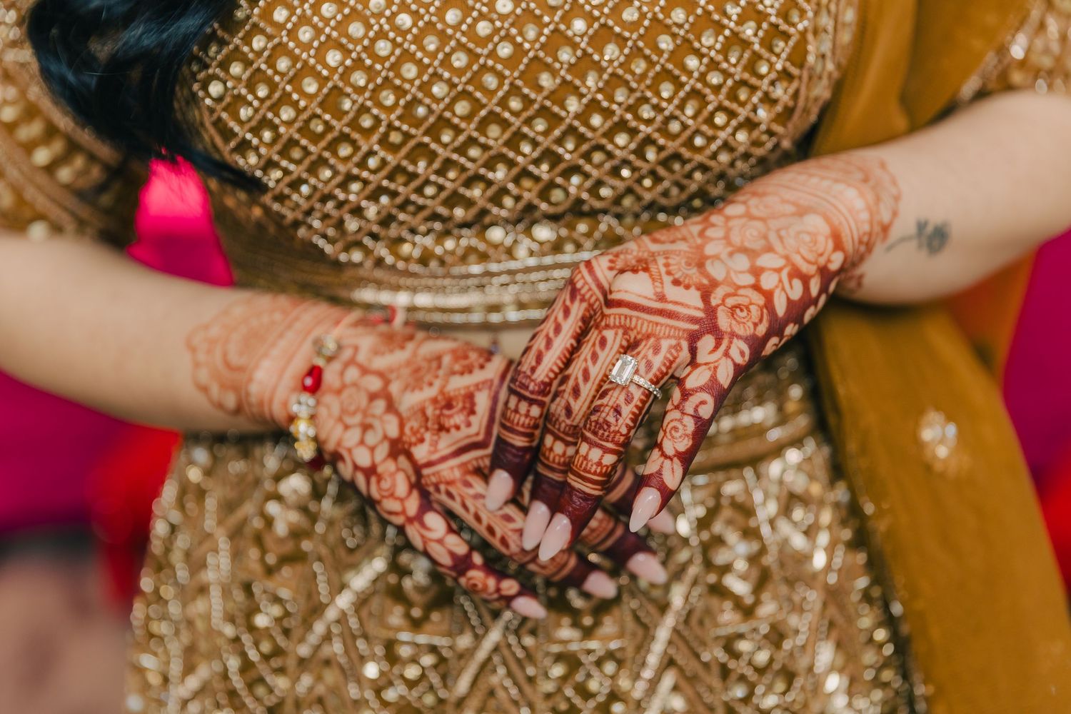 Intricate gold and red bridal jewelry and accessories displayed on a decorative surface.