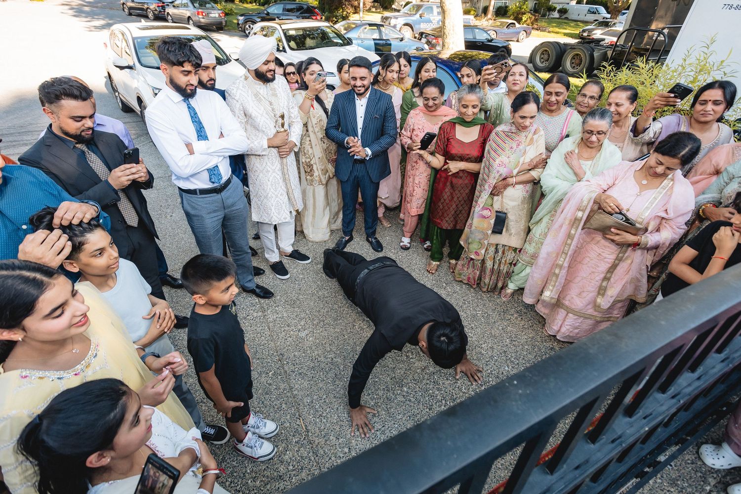 Wedding guests gathered outside forming lines for celebration.