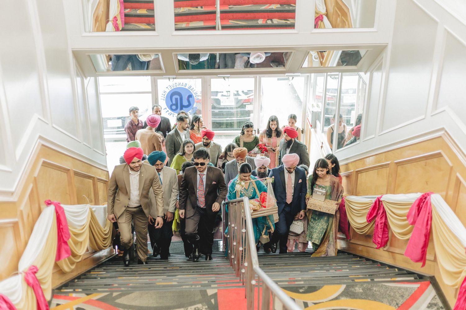 Grand wedding venue hallway decorated with gold drapes and elegant chandeliers at Punjab Banquet Hall Payal Business center Surrey