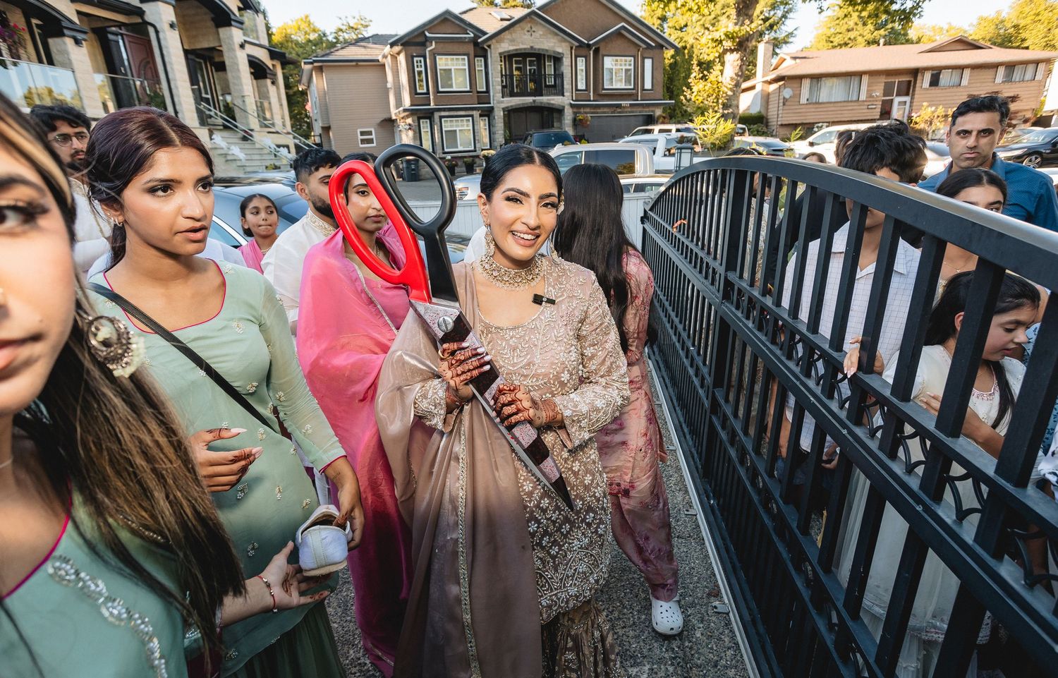 Outdoor gathering of people near residential buildings during autumn season.