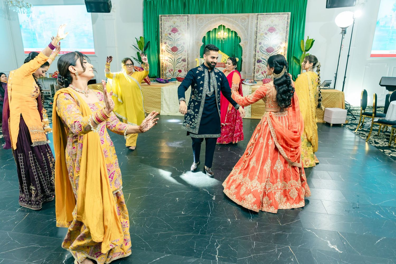 Traditional Indian dance celebration with performers in colorful outfits on stage.
