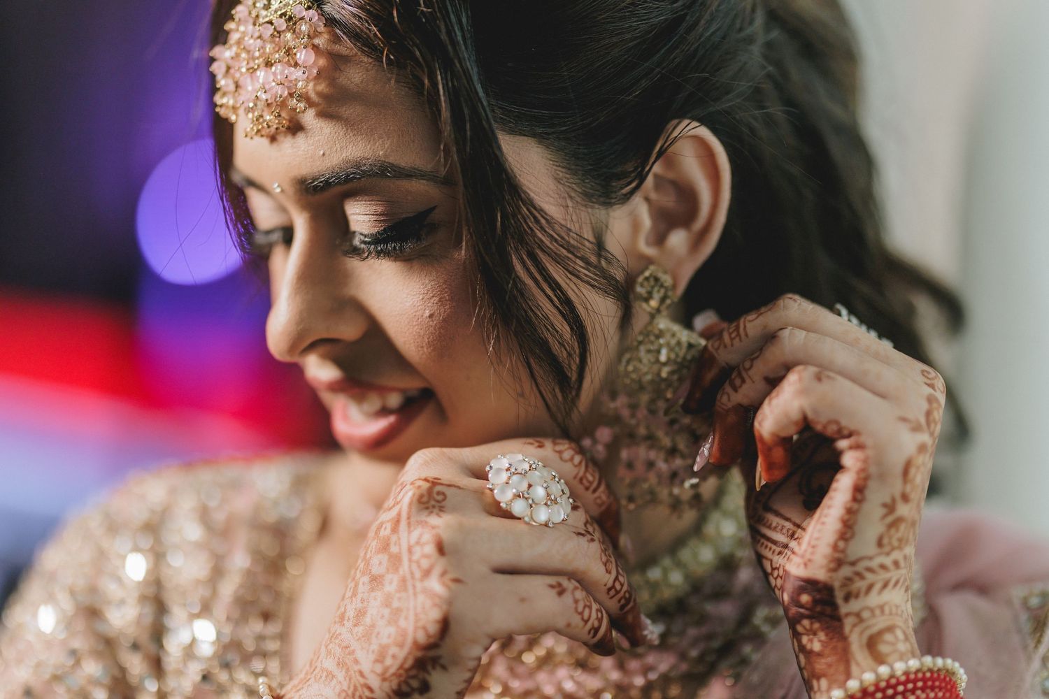 Close-up details of traditional South Asian bridal jewelry and accessories.