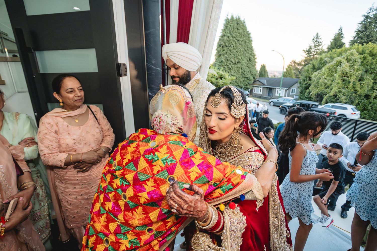Wedding celebration candid moments with bright floral arrangements and traditional attire.