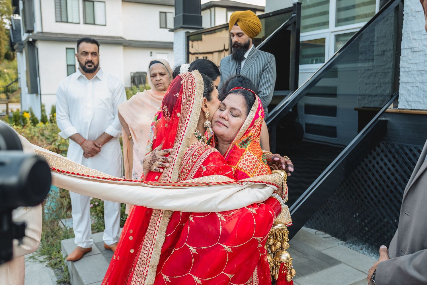 Wedding guests celebrate outdoors with traditional dance moves at a South Asian celebration.