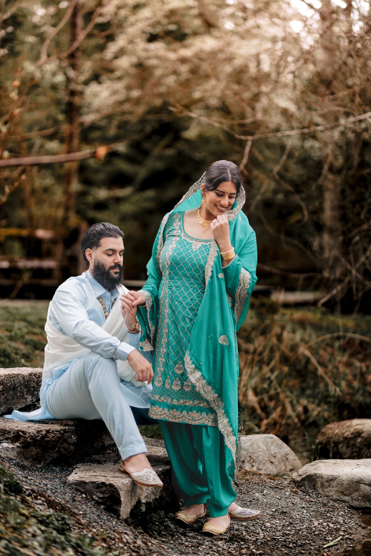 Intimate outdoor portrait session with traditional South Asian attire against a natural backdrop.