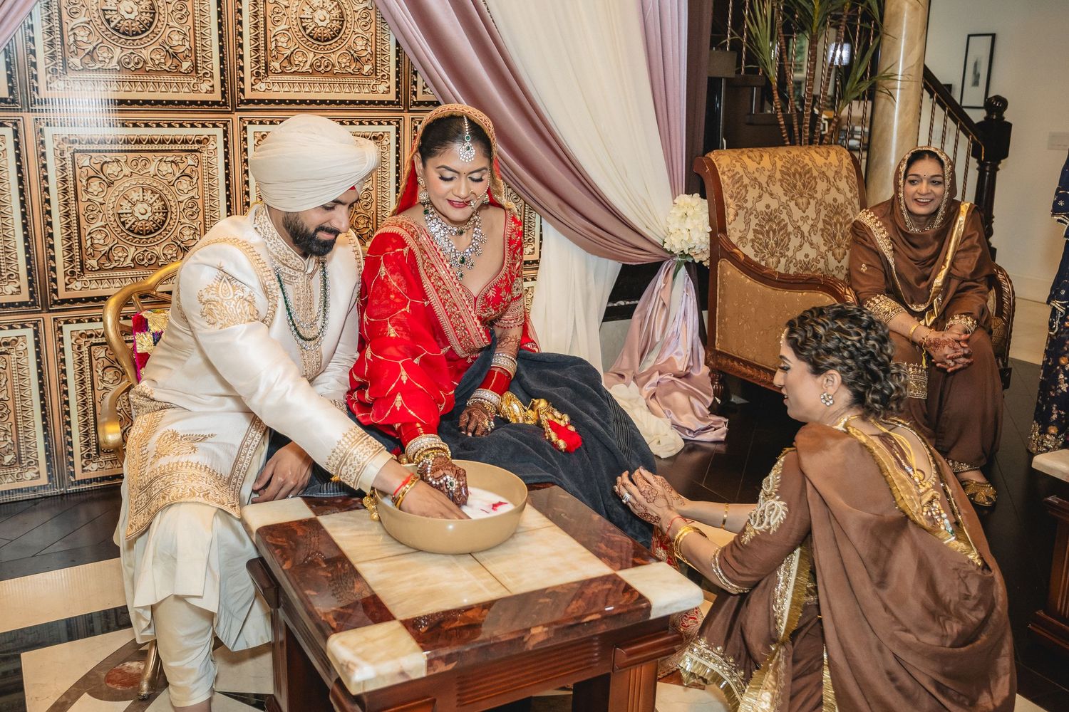Wedding ceremony participants gather around a table during traditional customs and rituals.