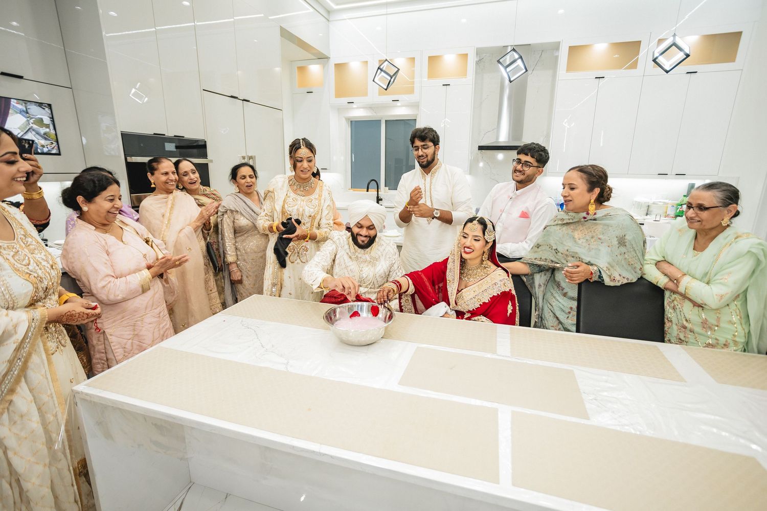 Wedding guests gathered around white tables during a reception celebration.