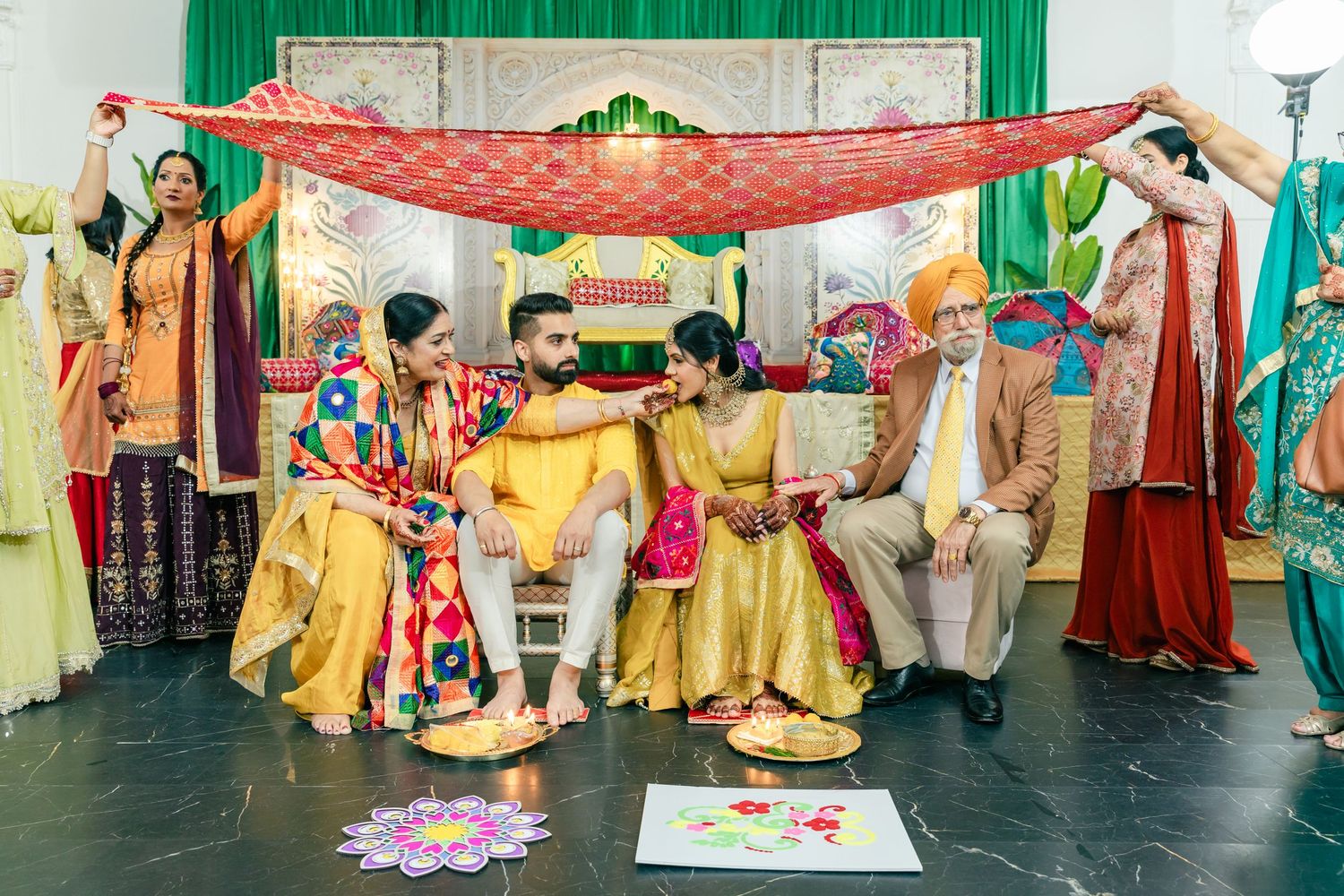 A group performs traditional Indian dance moves in yellow outfits during a cultural celebration.