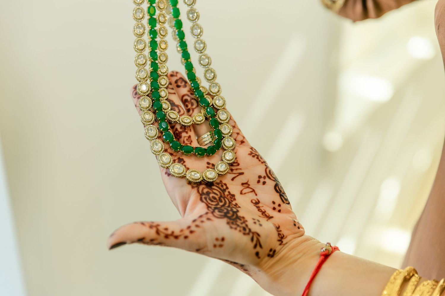 Intricate henna designs adorning hands with traditional Indian bridal jewelry and bangles.