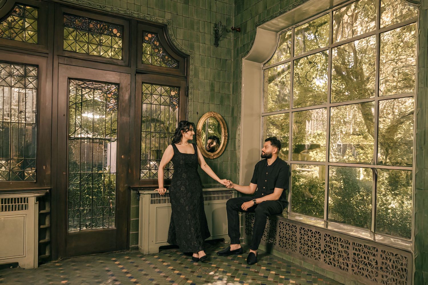 A romantic indoor photoshoot in an elegant conservatory with large windows and natural light.