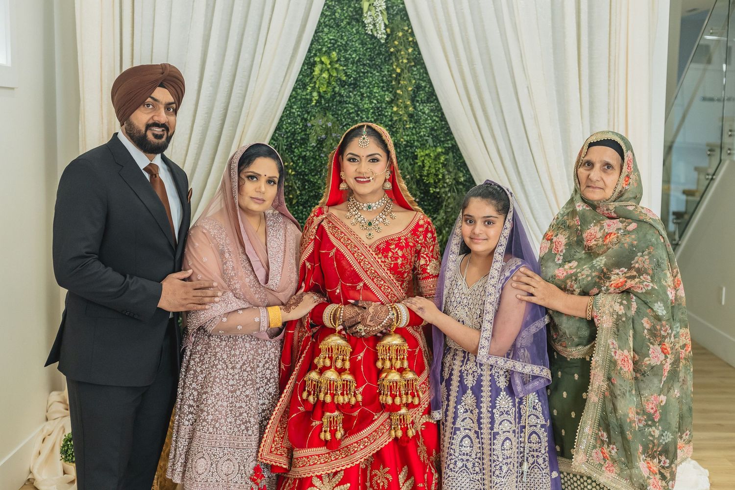 Traditional Indian wedding celebration with guests in colorful formal attire and elegant decor.