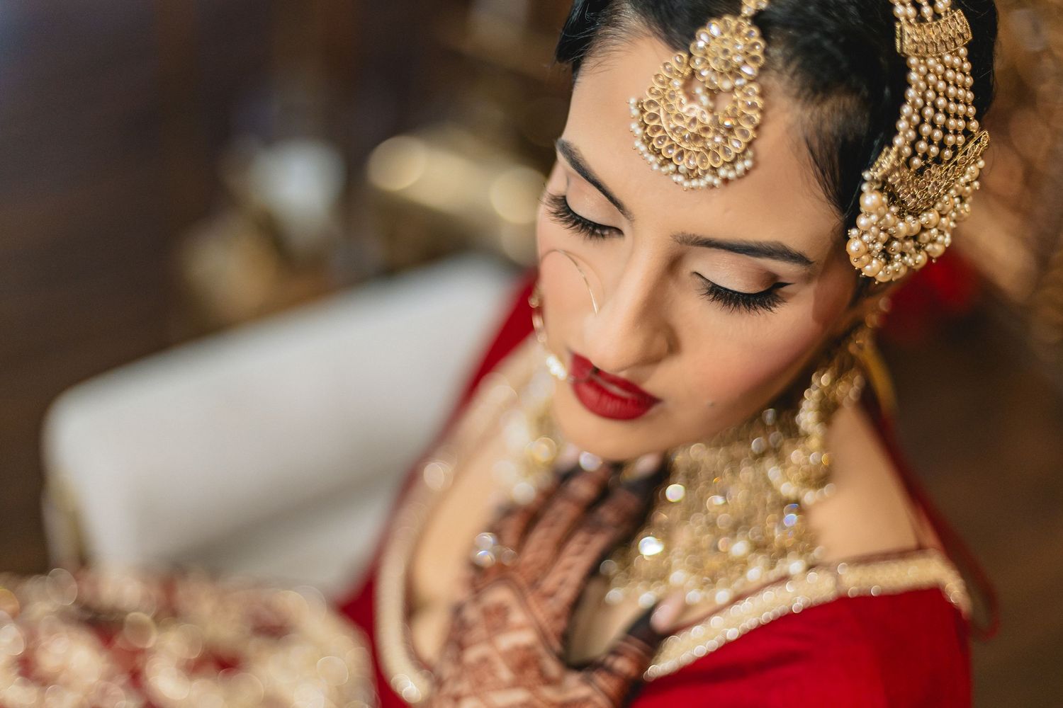 Close-up details of ornate gold Indian bridal jewelry and traditional wedding accessories.