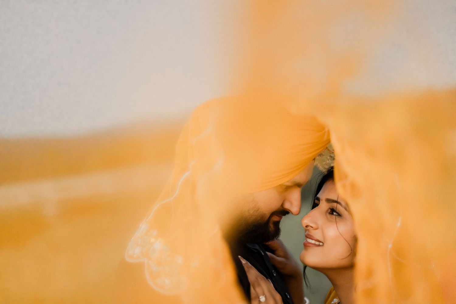 A dreamy golden-hour portrait session with soft orange light effects.