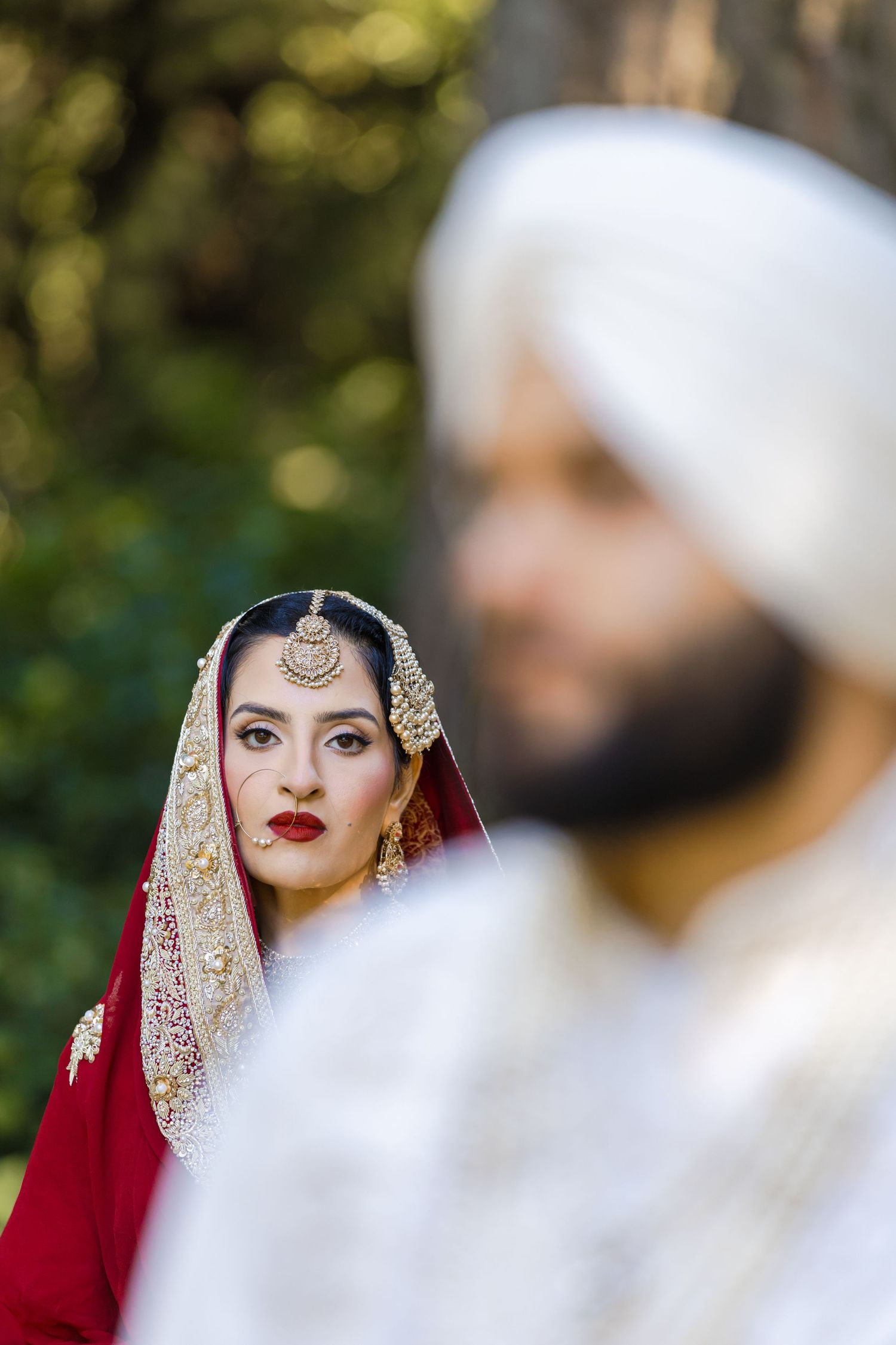 Artistic wedding photography session in natural outdoor setting.