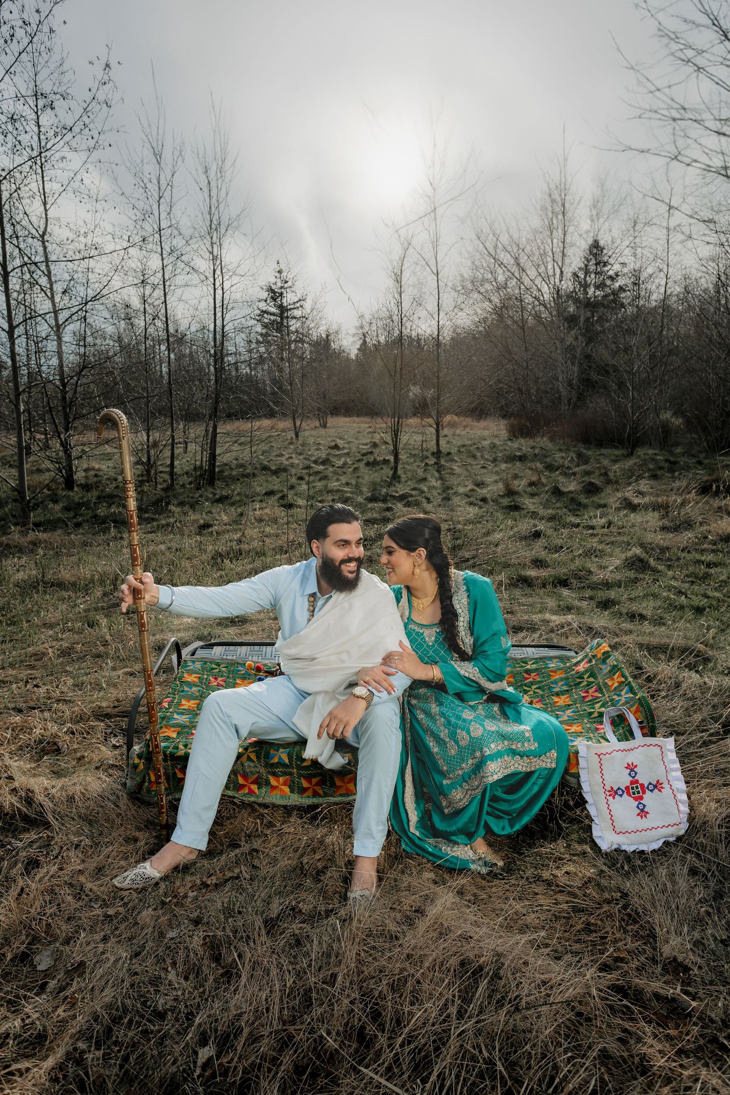 Couple lounges on blanket during styled vintage medical-themed outdoor photoshoot. Punjabi Style Pre Wedding Photoshoot
