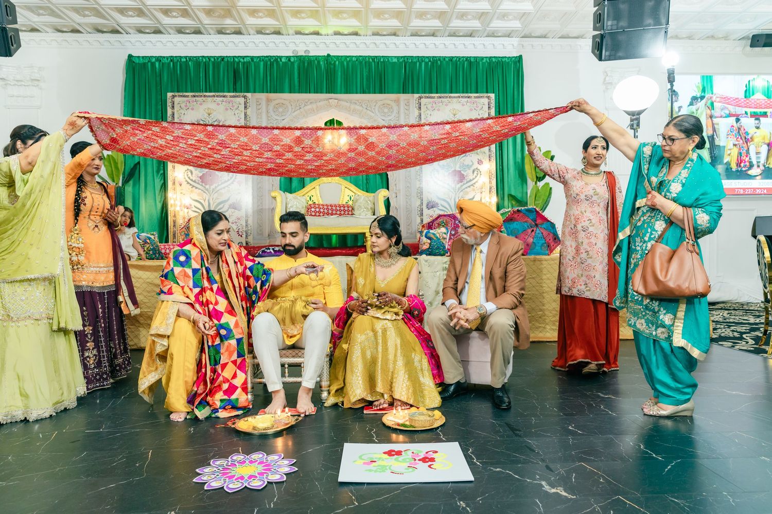 Dancers in vibrant yellow attire perform choreographed moves on a stage with colorful decorations.