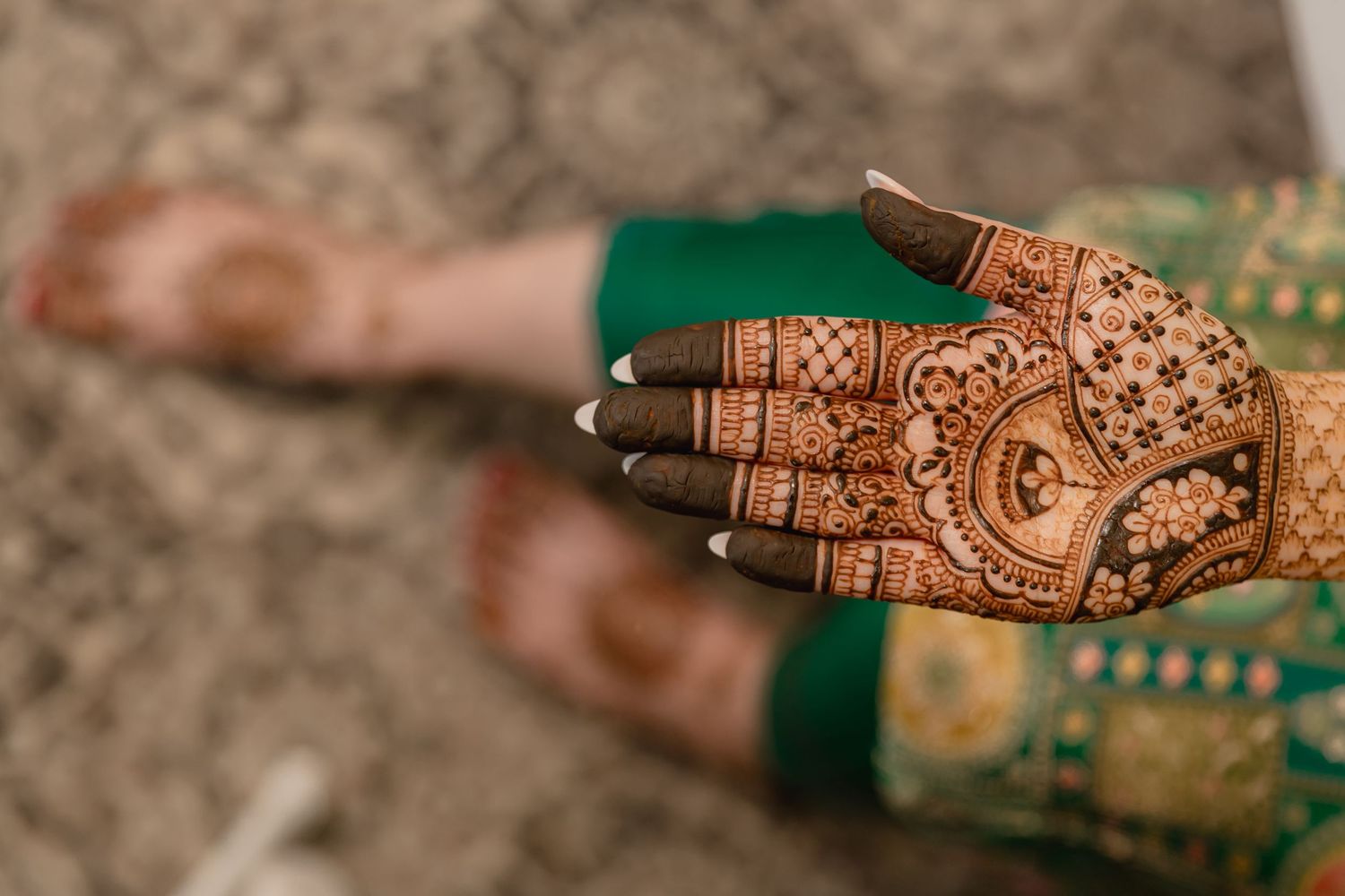 Traditional Mehndi artwork featuring intricate floral and paisley patterns.