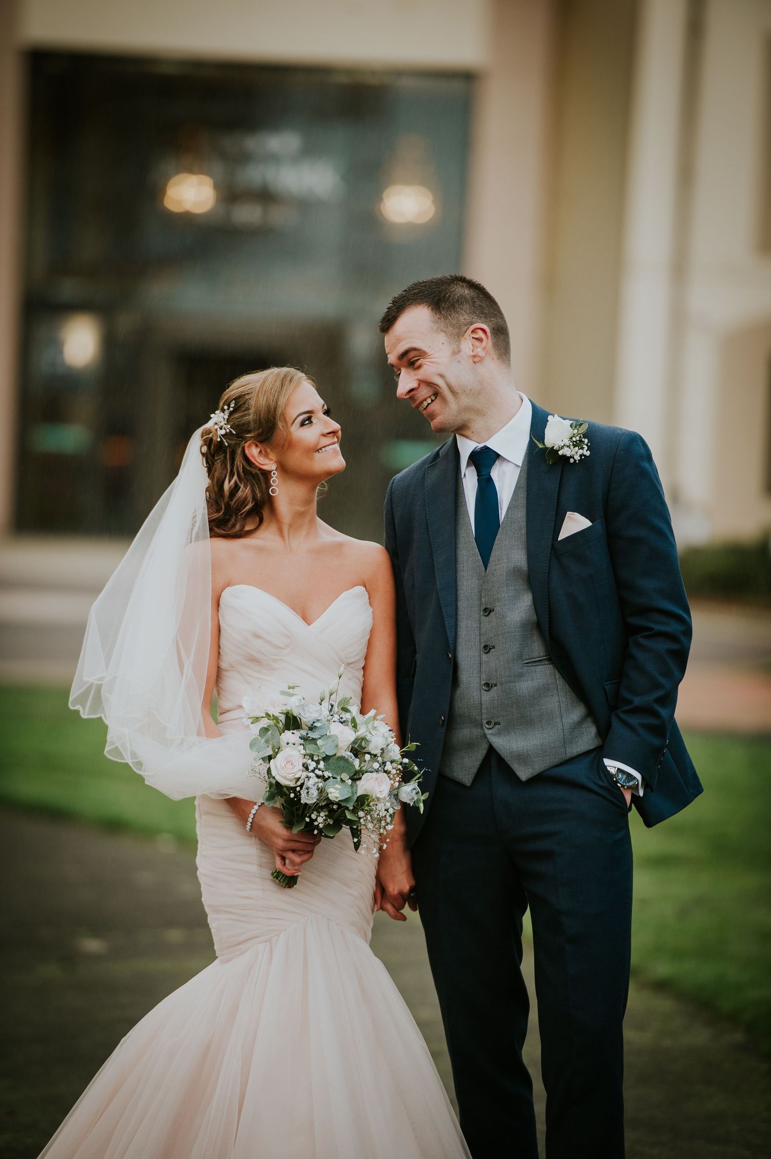 Romantic wedding couple sharing joyful moments outdoors.