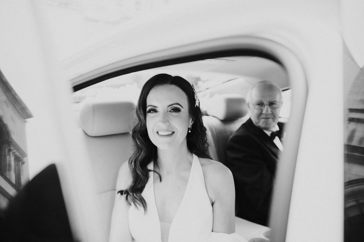 Elegant bride getting ready in car with classic vintage styling.