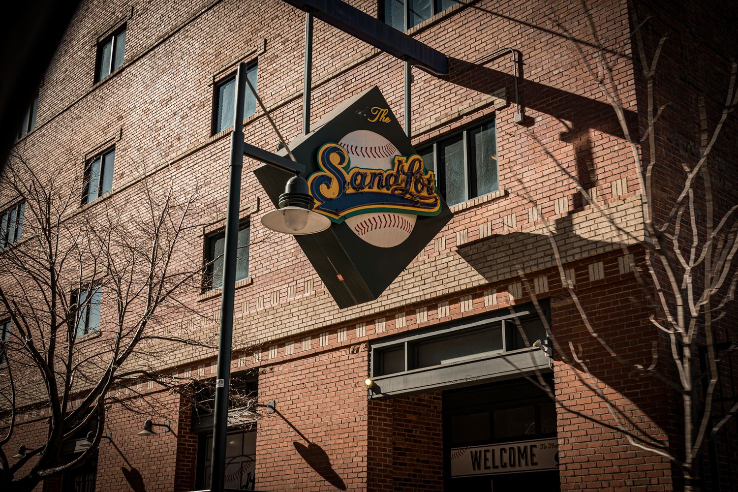 Vintage neon signs and brick buildings line a historic downtown street at dusk.