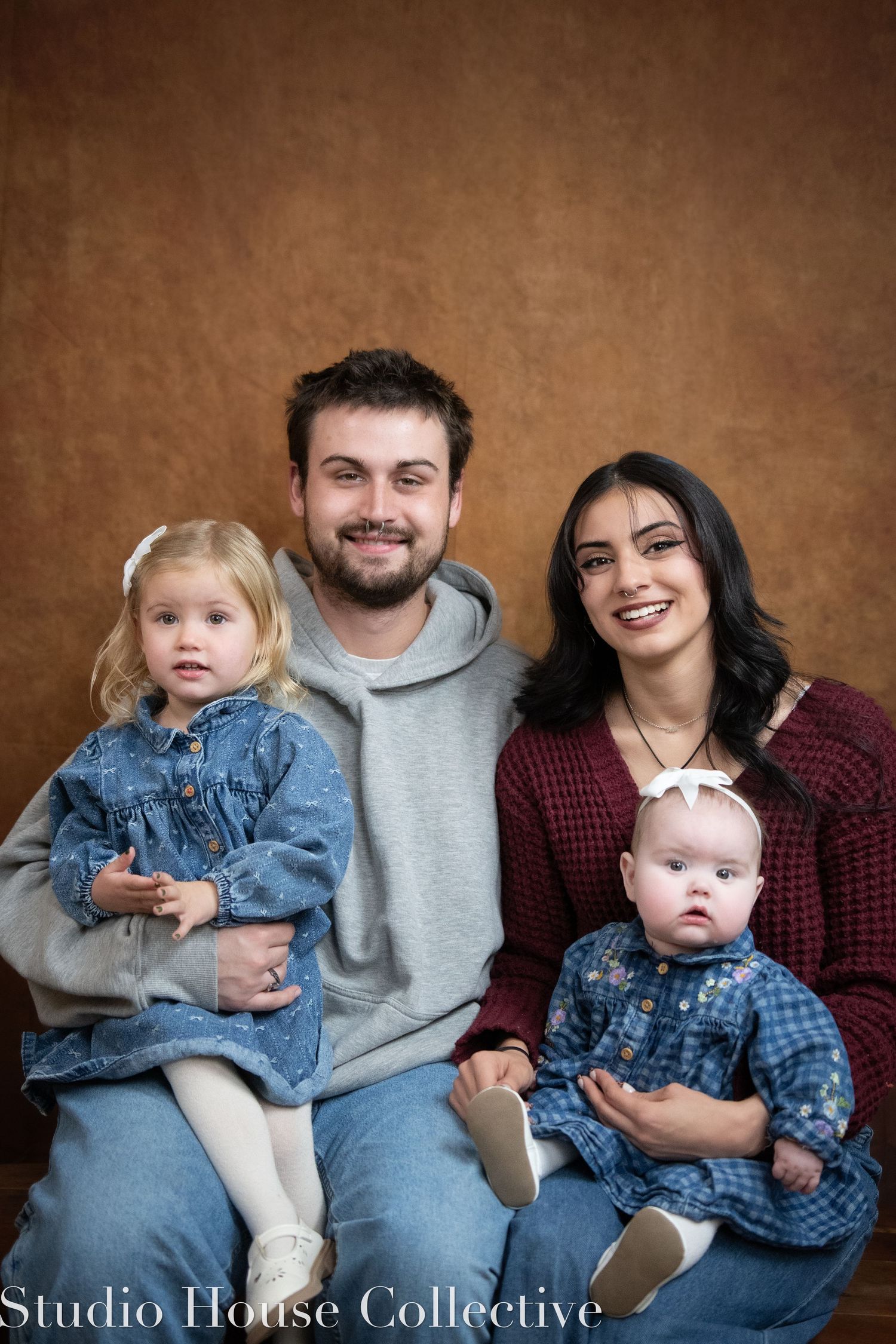Professional studio portraits showing family progression from single photo to full group shot against brown backdrop.