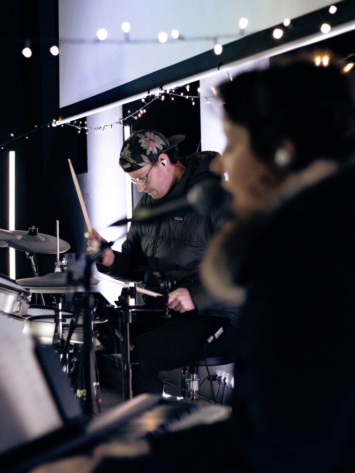 Drummer and pianist playing during church service.