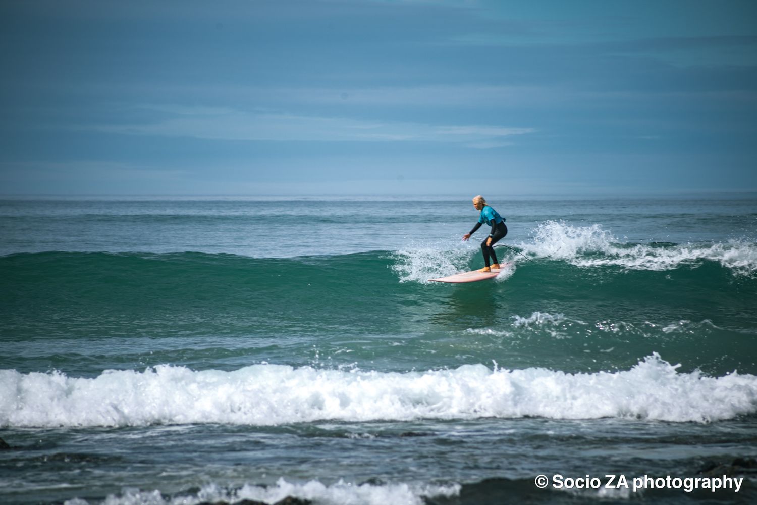 Surfer in the surf at Jeffreys Bay Eastern Cape standing on their surfboard.
