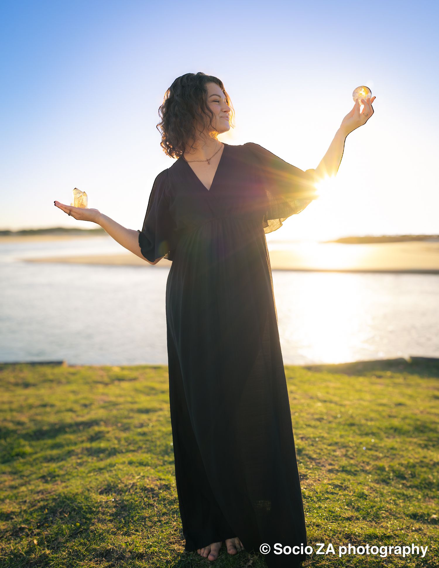 Portrait of a young woman while holding a crystal at sunrise. Portrait photography at the beach Eastern Cape Jeffreys Bay.