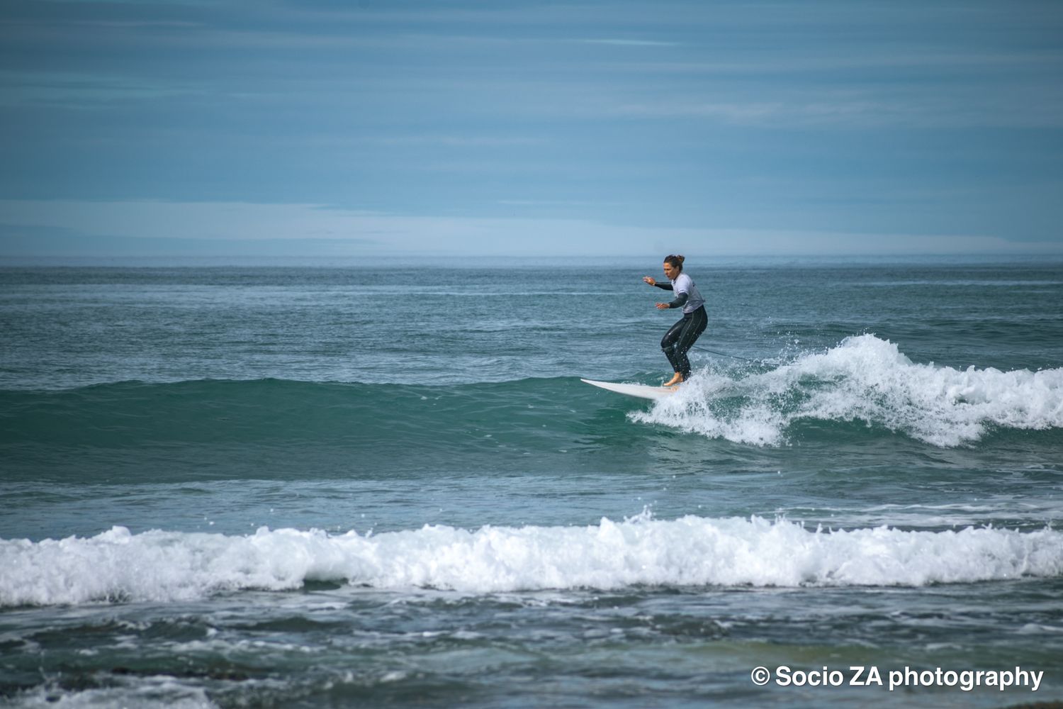 Surfer in the surf at Jeffreys Bay Eastern Cape standing on their surfboard.