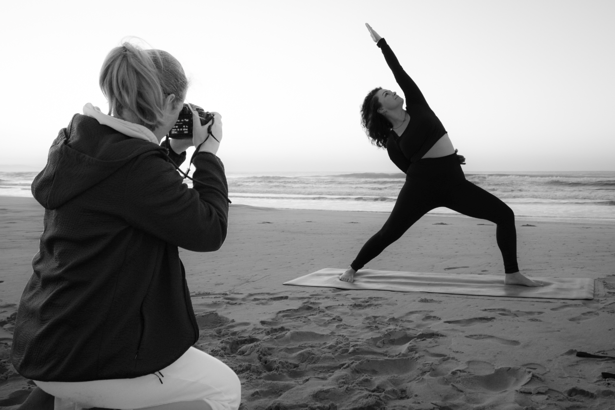 Photographer capturing Yoga poses on the beach. A photograph of a photographer taking pictures with a Canon camera in the Eastern Cape.