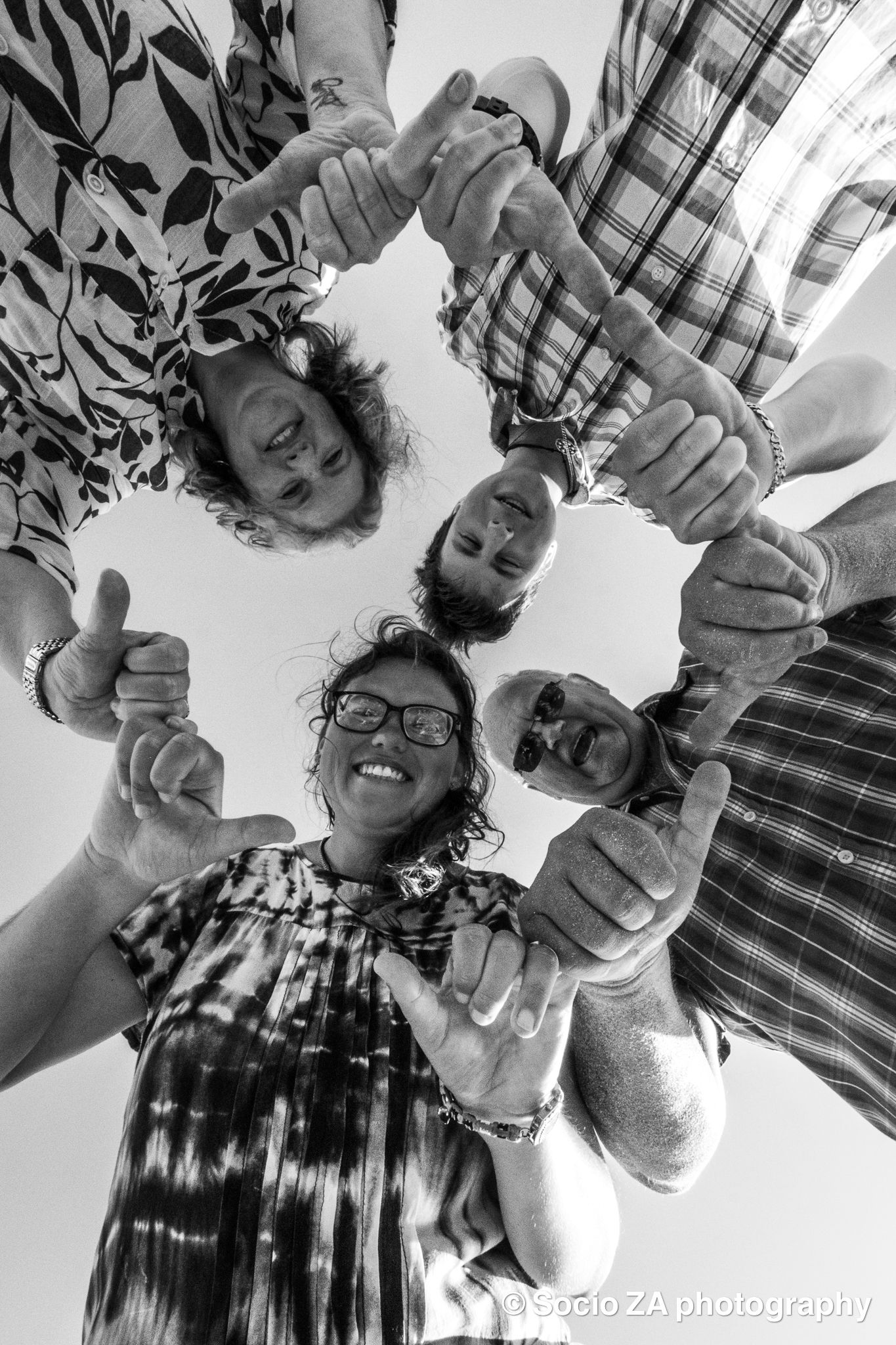 Creative group photoshoot in Jeffrey's Bay — overhead shot of family or group hands forming a circle, by Socio ZA Photography, Eastern Cape