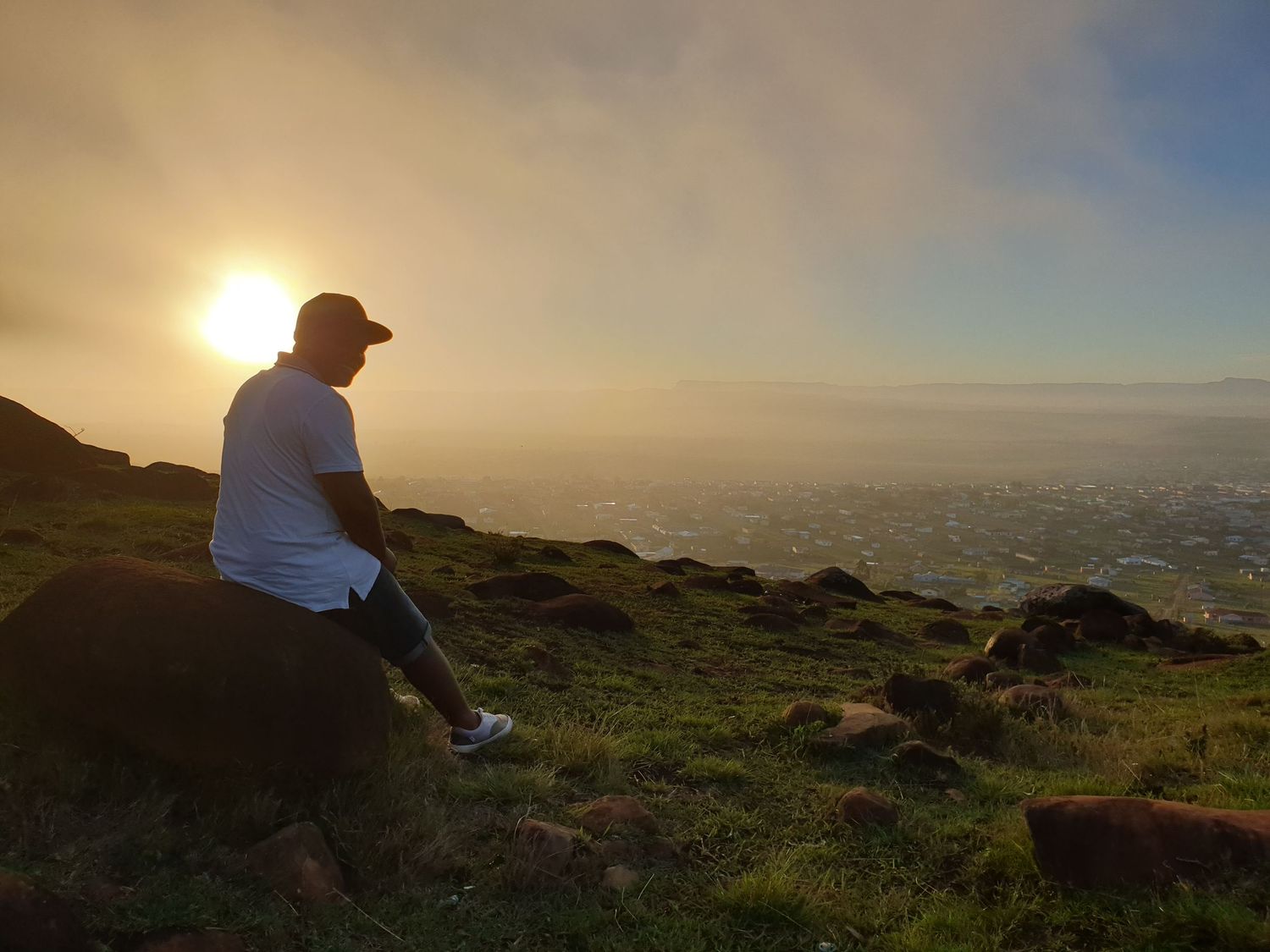 Sitting on top of a hill watching a sunset view in Mthatha.