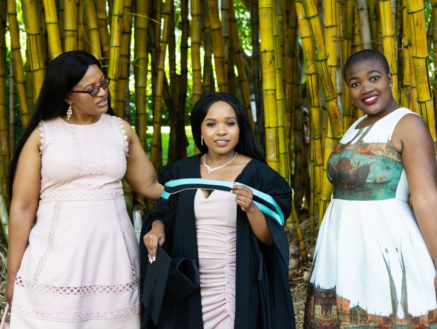 A graduate with family as they participate in a photoshoot in Durban.