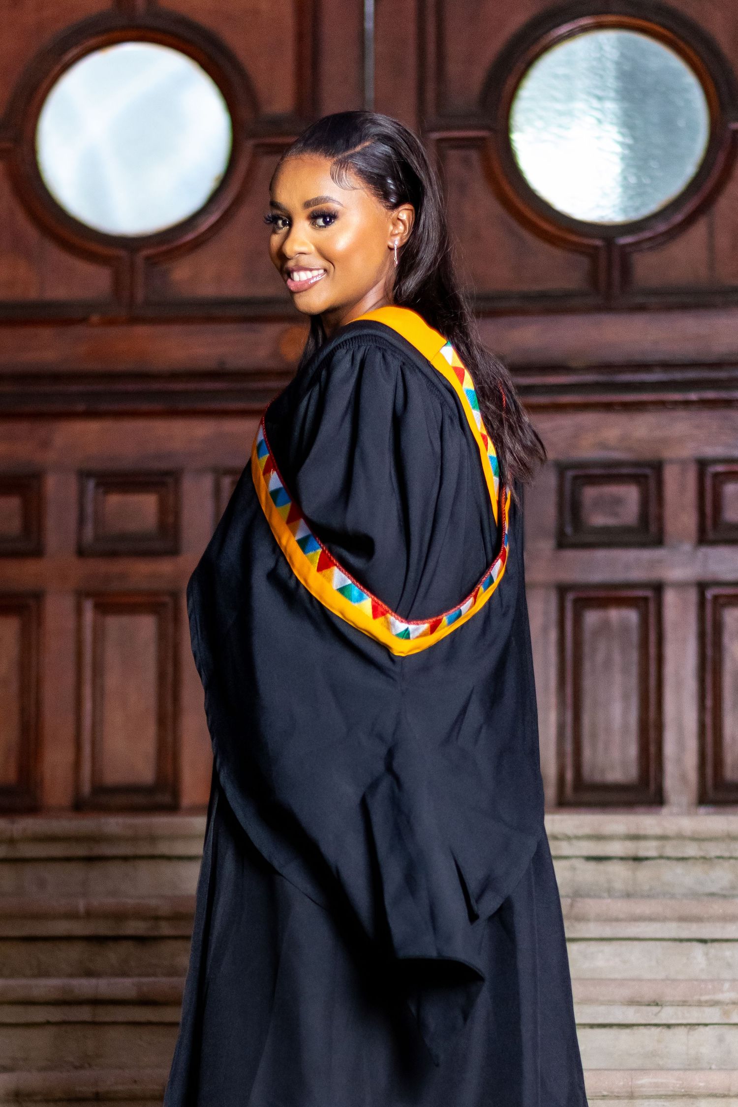 A graduate smiles for a photo as she participates in a graduation photoshoot held in Durban.
